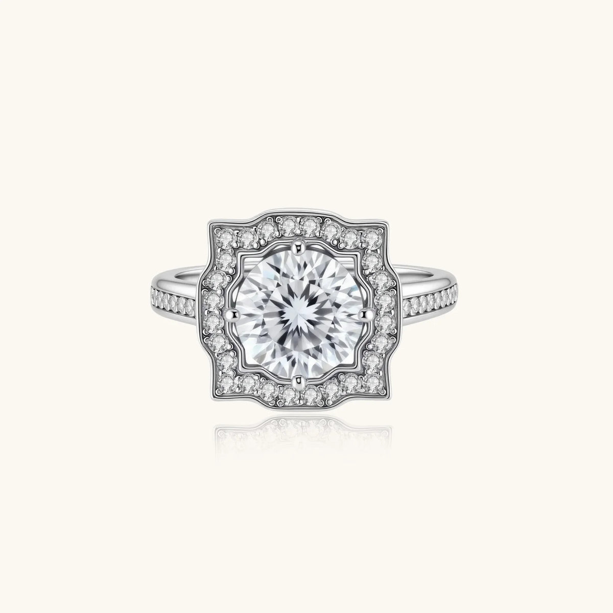 Sterling silver ring with round moissanite center stone in ornate scalloped halo setting on white background.