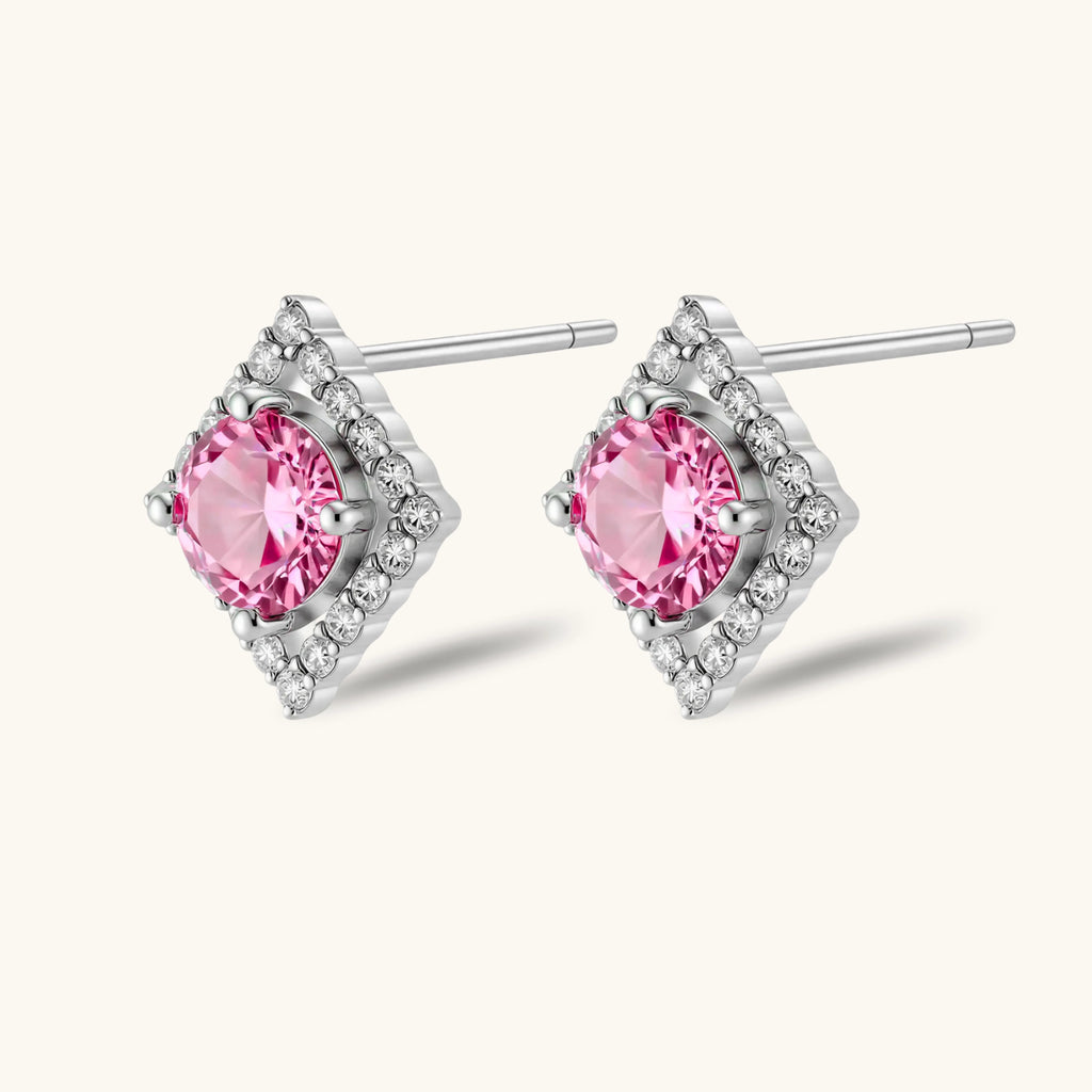 Sterling silver diamond-shaped stud earrings with pink moissanite center stones and crystal halo setting on white background