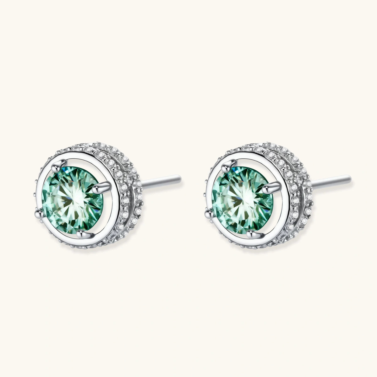 Round green moissanite stud earrings in sterling silver halo settings with brilliant sparkle on white background.