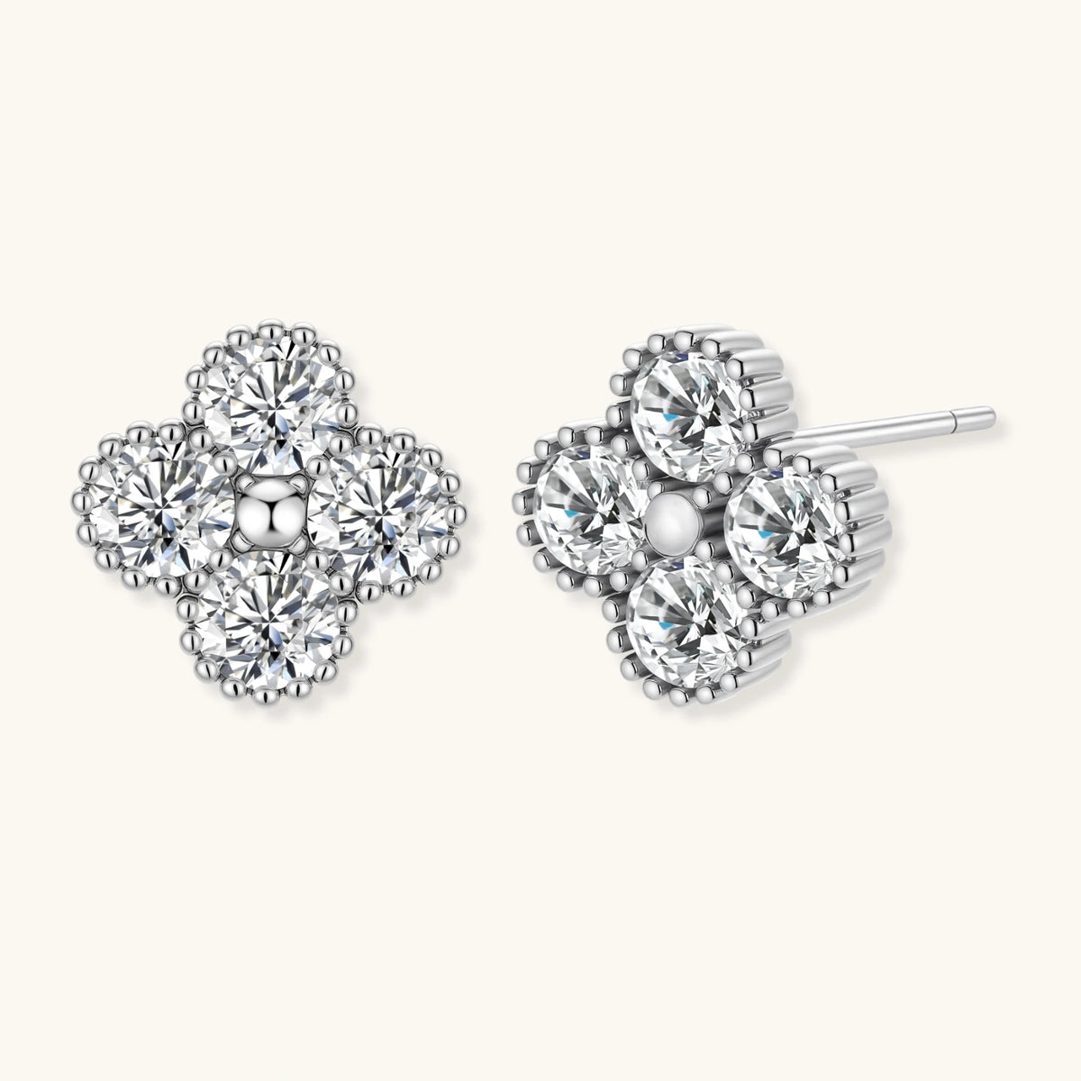 Dainty sterling silver quatrefoil stud earrings with four brilliant moissanite stones and center accent on white background.