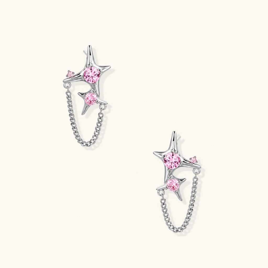 Pair of silver star-shaped ear climbers with pink zirconia stones connected by delicate chains