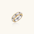 Two-tone ring with brushed silver center, gold beaded edges, and blue zirconia stones on white background.